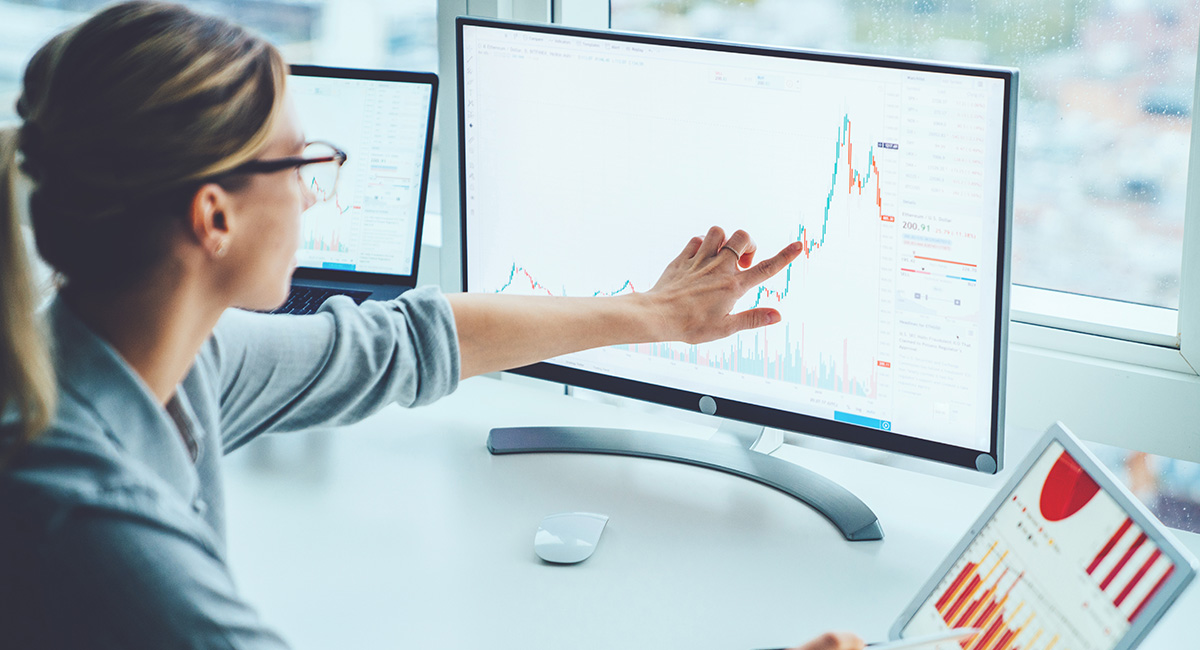 woman pointing at computer screen